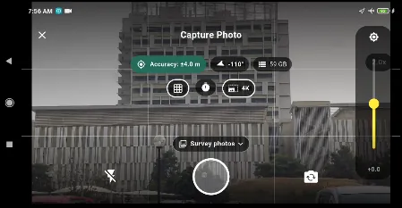 The camera in landscape: the badge at the top reports the fix (&plusmn;4.0 m, heading, altitude), the grid helps you frame the shot, and the chip over the shutter says where the photo is going. Here, into the survey&rsquo;s standalone photos.
